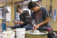 Students making pottery. Link to What to Give